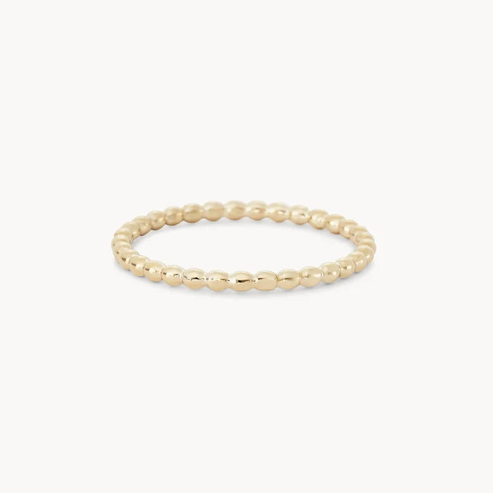 A delicate abacus ring - 10k yellow gold is shown on a plain white background. The ring, from bluboho, features a simple yet elegant design with small, evenly spaced spherical beads forming a continuous circle.
