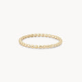 A delicate abacus ring - 10k yellow gold is shown on a plain white background. The ring, from bluboho, features a simple yet elegant design with small, evenly spaced spherical beads forming a continuous circle.