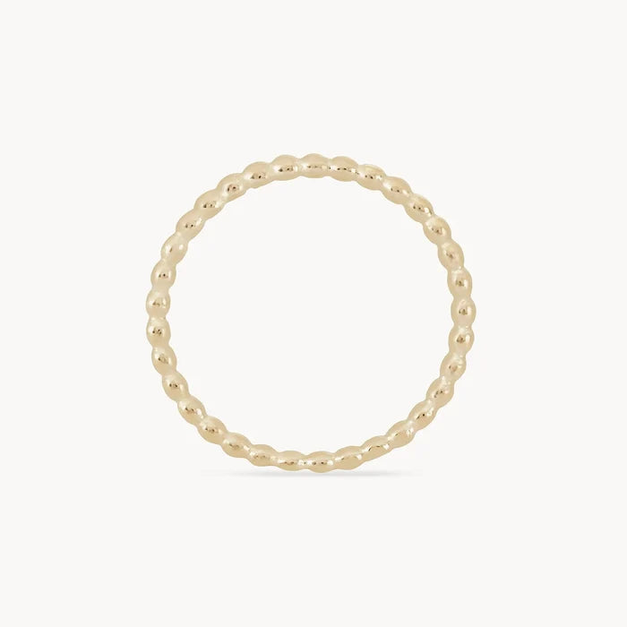 A delicate abacus ring - 10k yellow gold with a beaded design, featuring small, rounded beads connected in a continuous circle by bluboho. The ring is set against a plain white background.