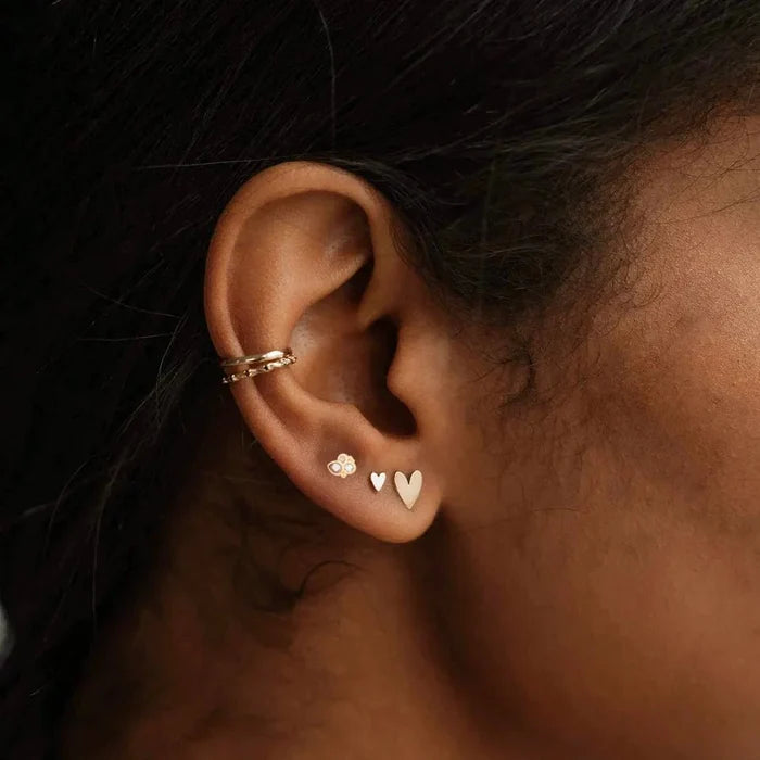 Air Element Stud Earring in 14k yellow gold, shown worn on hand