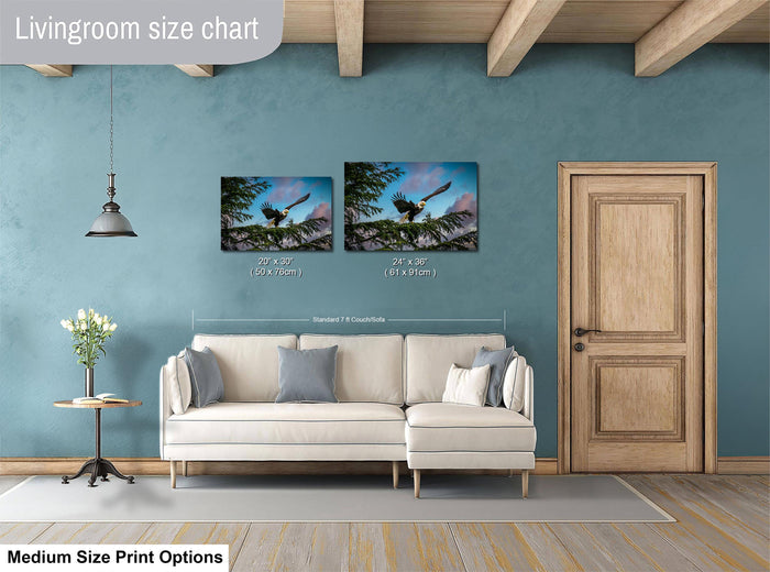 a living room with a white sofa, a wooden door, and a painting of a bird on a branch hanging on the wall.