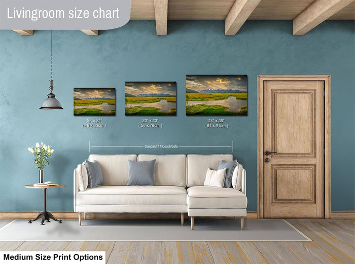 a living room with a white sofa and a wooden door. Above the sofa, there is a livingroom size chart that provides the dimensions of three landscape paintings in feet and inches.