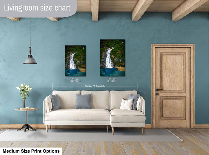 a living room with a white sofa, a wooden door, and a painting of a waterfall on the wall. The painting is of a standard size of 14 x 16 inches.