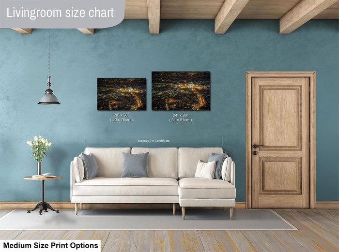 a living room with a white sofa, a wooden door, and a painting of a cityscape hanging on the wall.