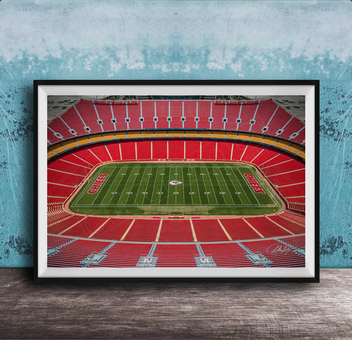 The image is a framed photograph of a football stadium, specifically the Kansas City Chiefs stadium, with a focus on the field and seating areas.