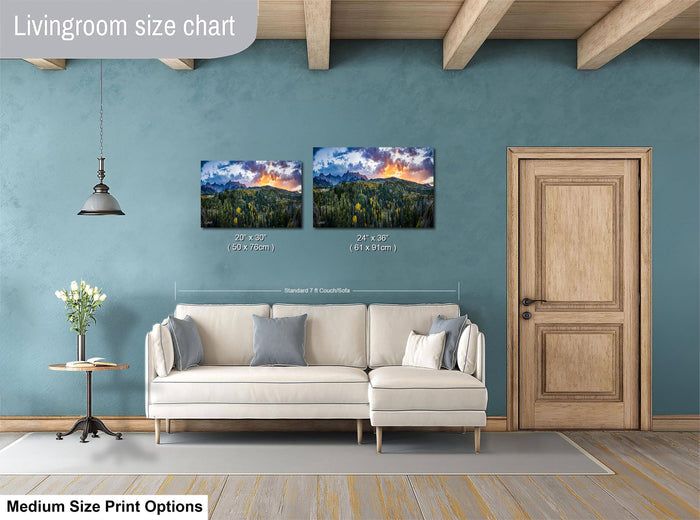a living room with a white sofa, a wooden door, and a painting of a mountain landscape on the wall. The living room appears to be well-lit and decorated with a modern style.
