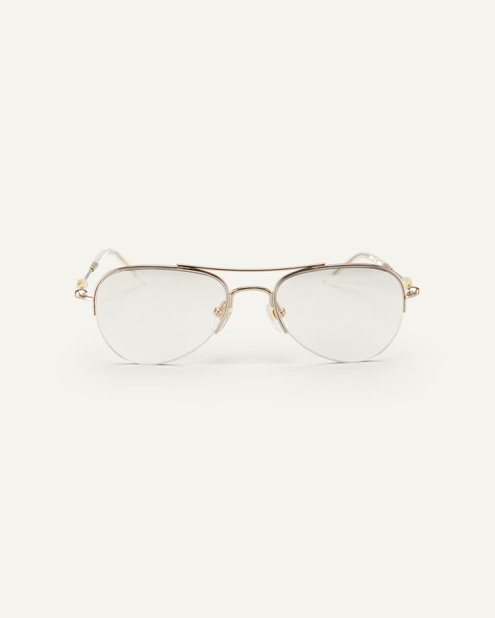 Face shot of Bonnie Clyde Autobio aviator optical frames in gold with clear lenses.