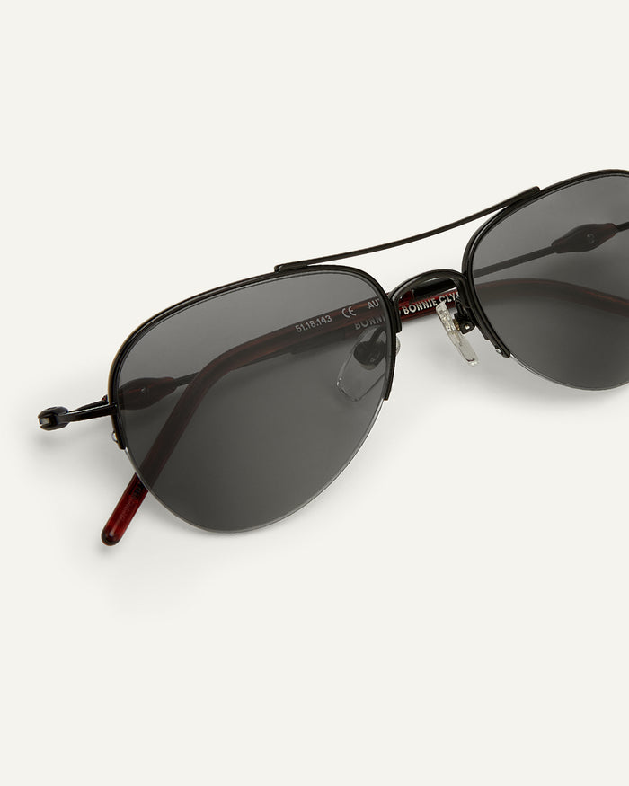 Side shot of Bonnie Clyde Autobio aviator sunglasses in black with black lenses.