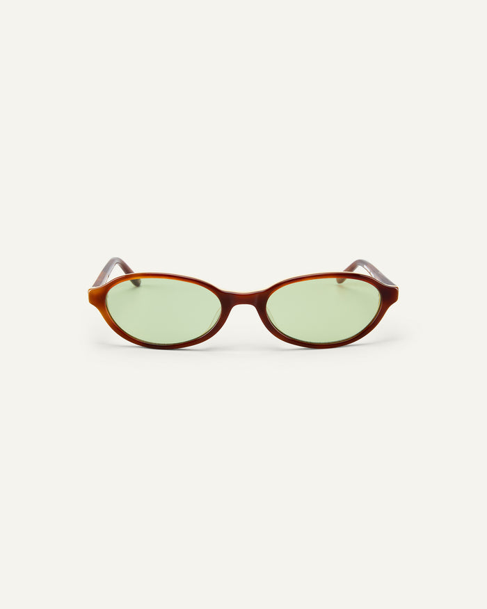 Face shot of Bonnie Clyde Baby oval sunglasses in layered brown with green lenses.