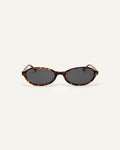 Face shot of Bonnie Clyde Baby oval sunglasses in tortoise with black lenses.