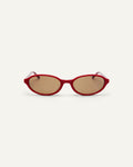Face shot of Bonnie Clyde Baby oval sunglasses in layered red with brown lenses.