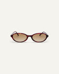 Face shot of Bonnie Clyde Baby oval sunglasses in red tortoise with brown gradient lenses.