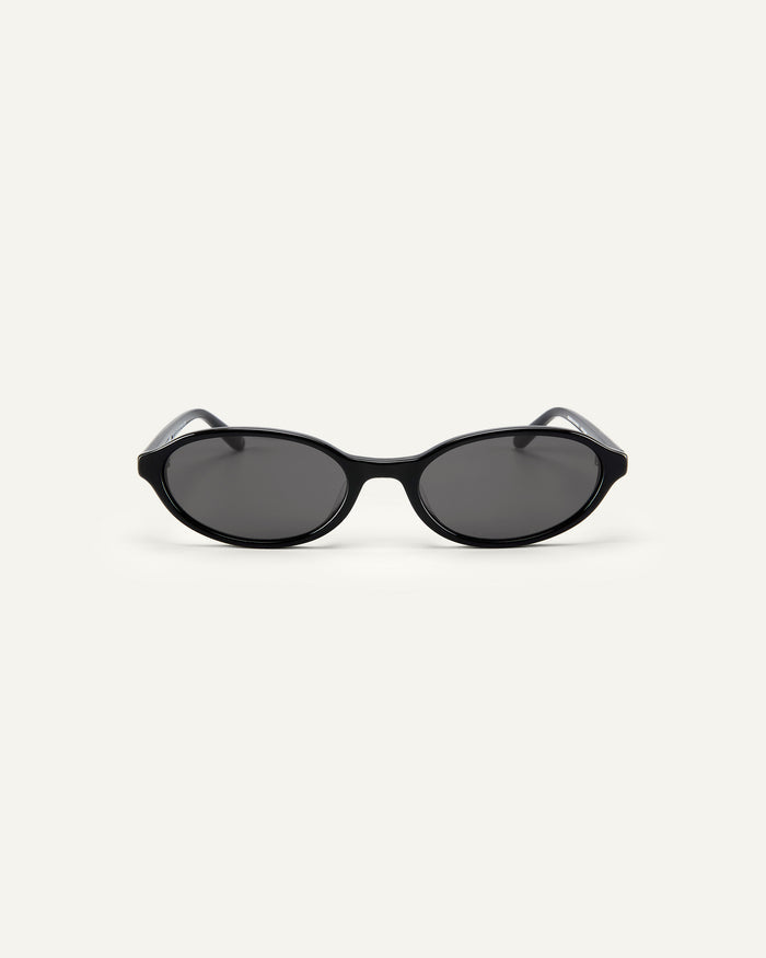 Face shot of Bonnie Clyde Baby oval sunglasses in black with black lenses.