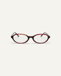 Face shot of Bonnie Clyde Baby oval optical frames in red tortoise with clear lenses.