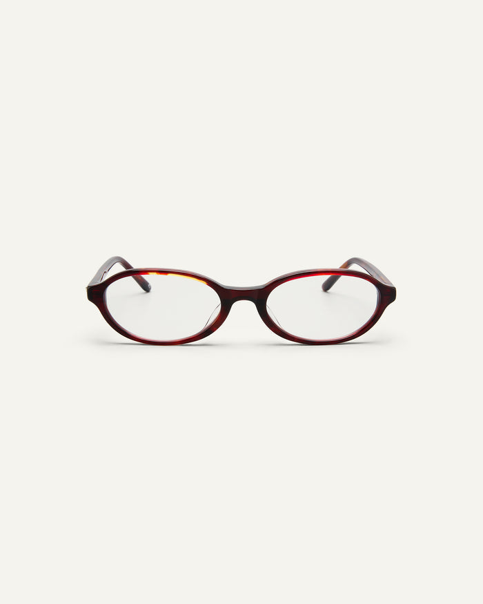 Face shot of Bonnie Clyde Baby oval optical frames in red tortoise with clear lenses.