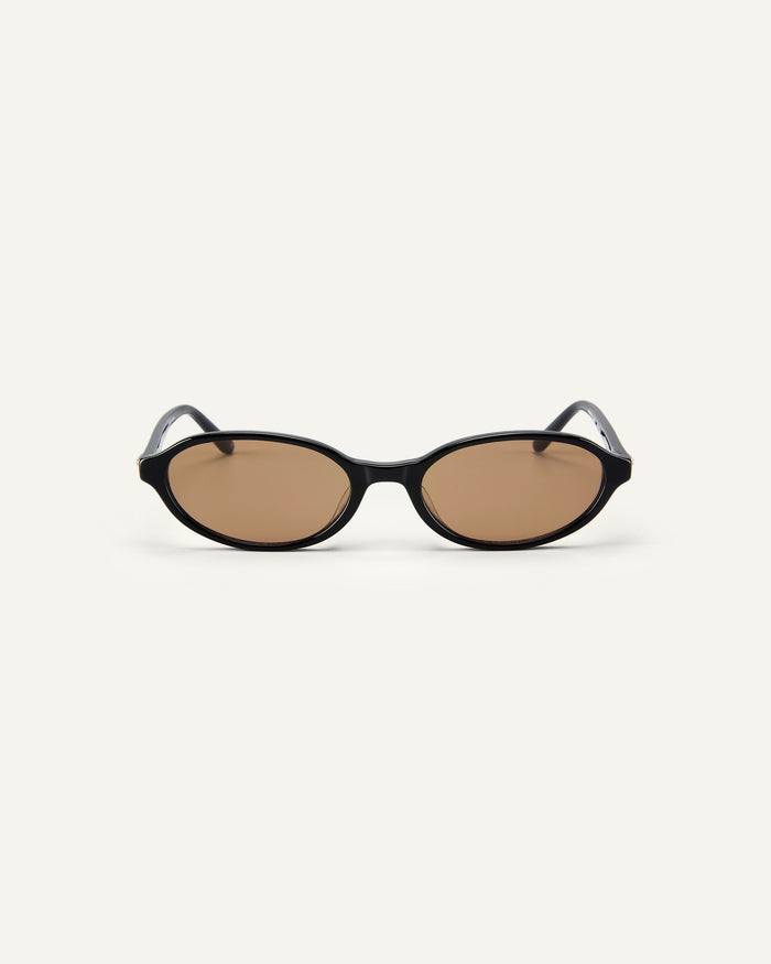 Face shot of Bonnie Clyde Baby oval sunglasses in black with brown lenses.