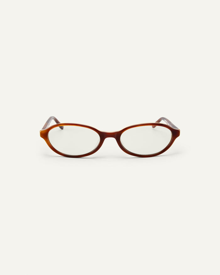 Face shot of Bonnie Clyde Baby oval optical frames in layered brown with clear lenses.