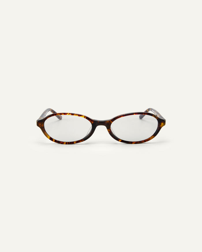 Face shot of Bonnie Clyde Baby oval optical frames in tortoise with clear lenses.