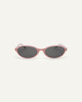 Face shot of Bonnie Clyde Baby oval sunglasses in layered pink with black lenses.