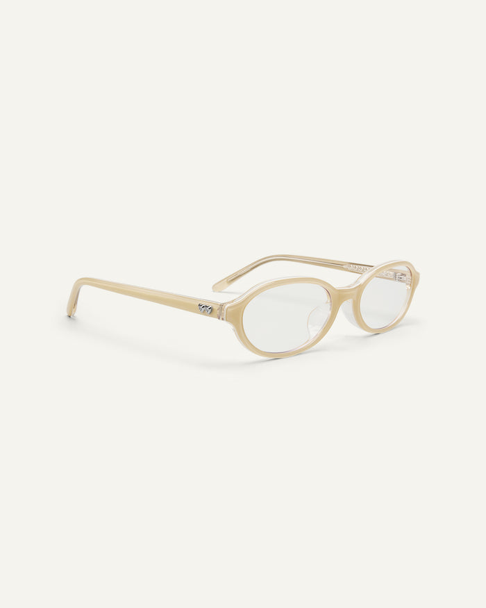Side shot of Bonnie Clyde Baby oval optical frames in layered off white with clear lenses.