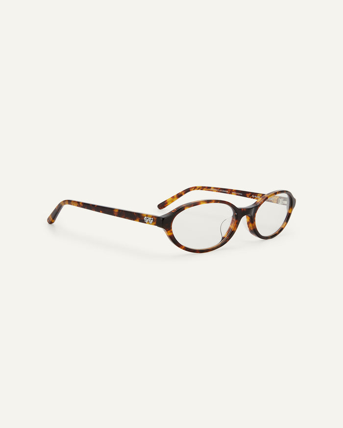 Side shot of Bonnie Clyde Baby oval optical frames in tortoise with clear lenses.