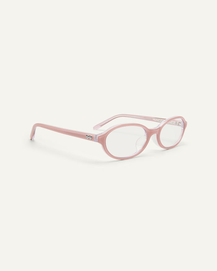 Side shot of Bonnie Clyde Baby oval optical frames in layered pink with clear lenses.