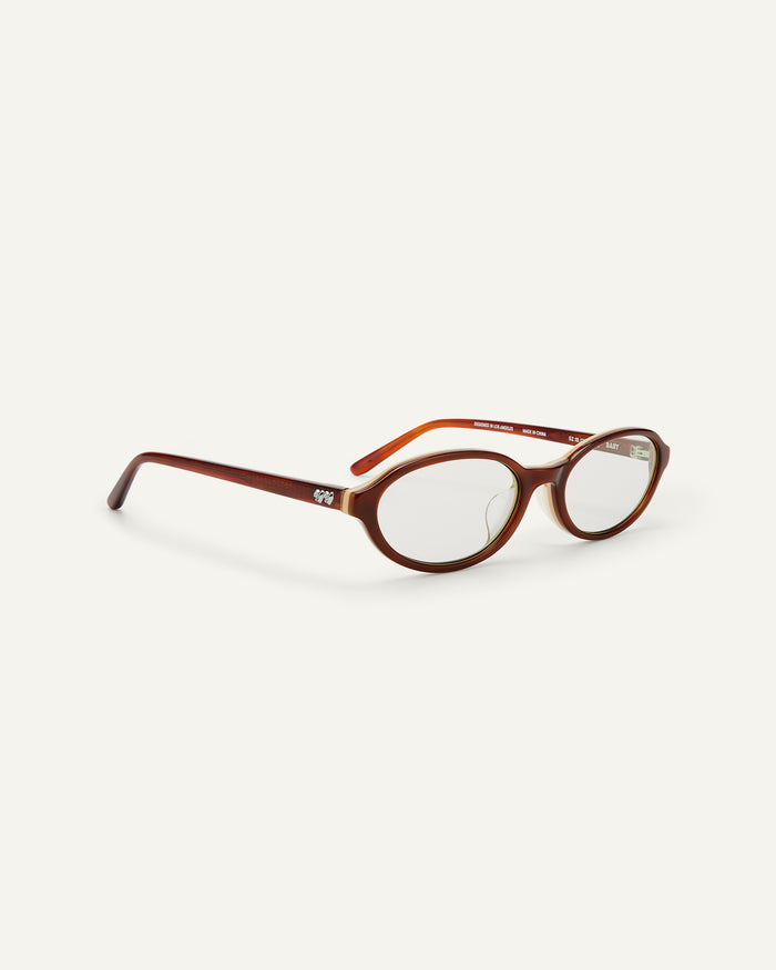 Side shot of Bonnie Clyde Baby oval optical frames in layered brown with clear lenses.