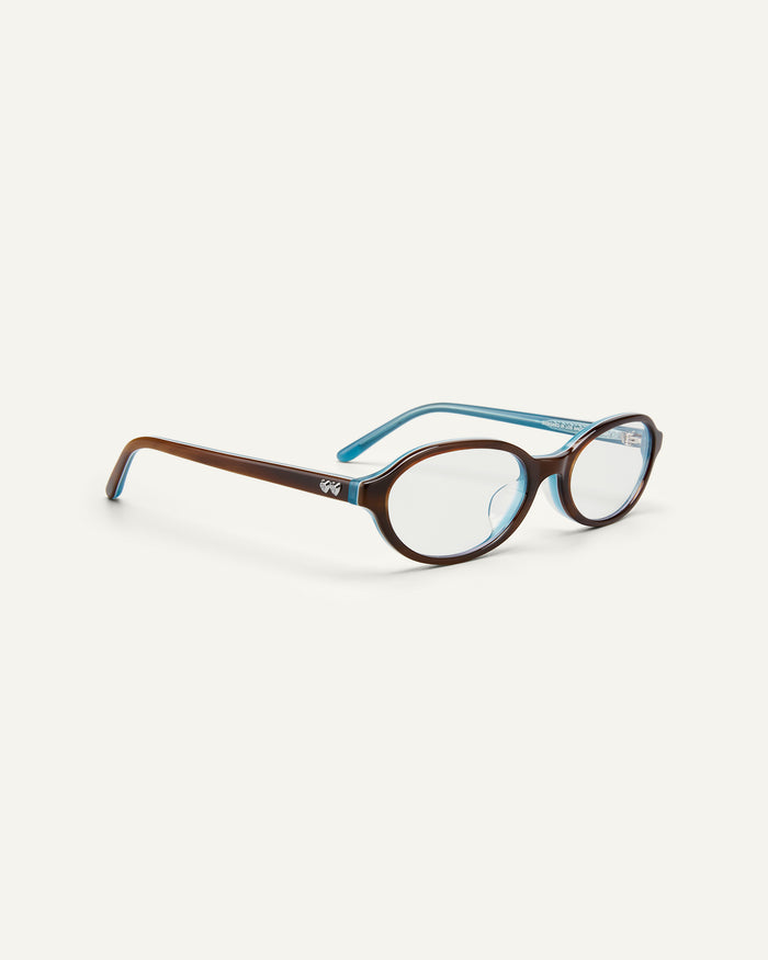Side shot of Bonnie Clyde Baby oval optical frames in teal demi with clear lenses.