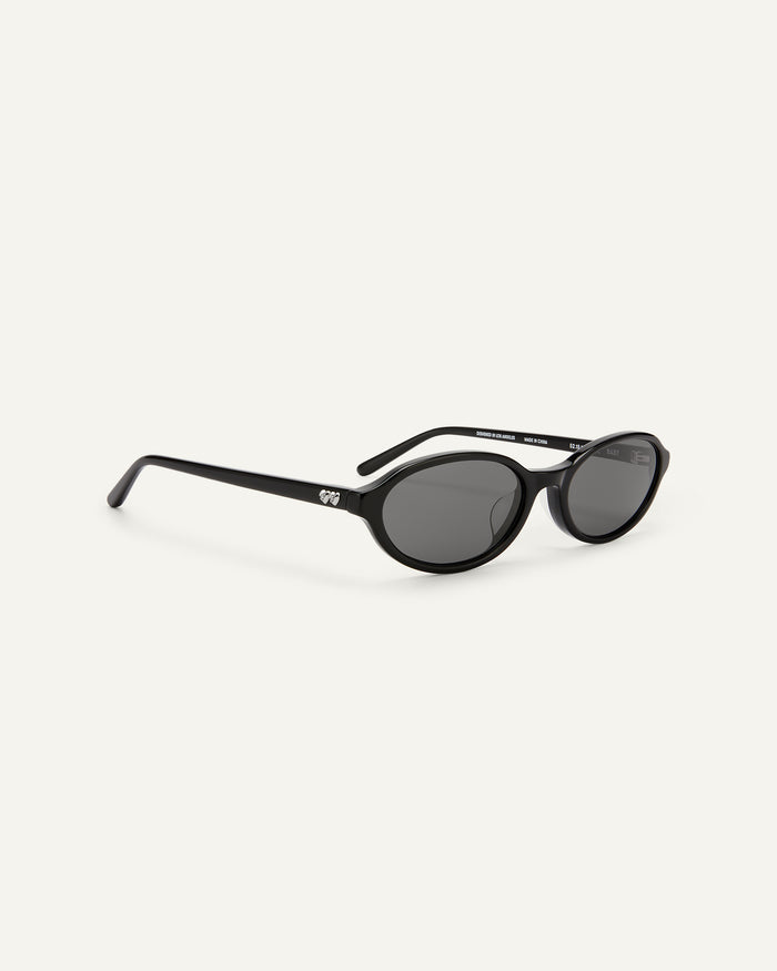 Close-up shot of Bonnie Clyde Baby oval sunglasses in black with black lenses.
