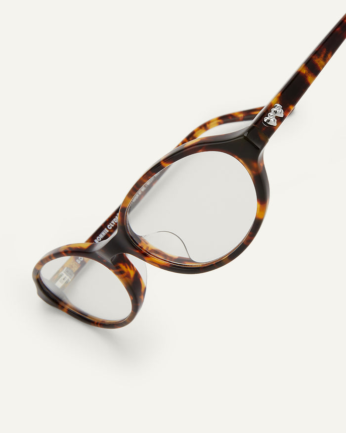 Detail shot of Bonnie Clyde Baby oval optical frames in tortoise with clear lenses.