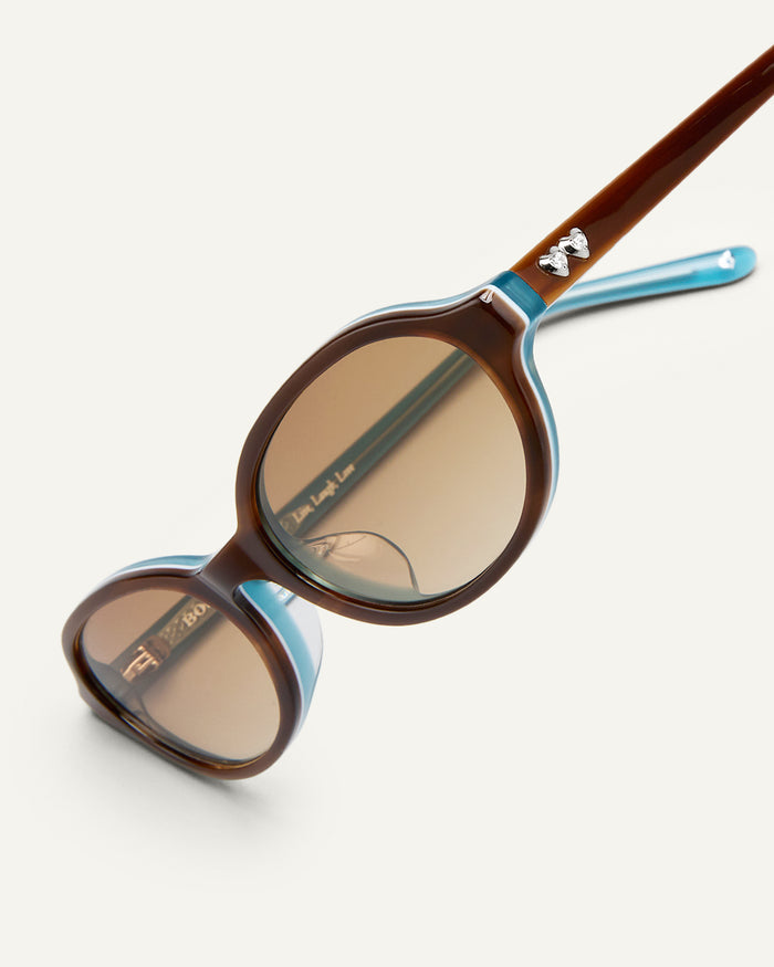 Additional view of Bonnie Clyde Baby oval sunglasses in layered teal demi with brown gradient lenses.