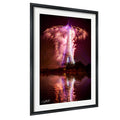 a large, illuminated tower with a vibrant display of fireworks in the night sky, reflected in the water below.