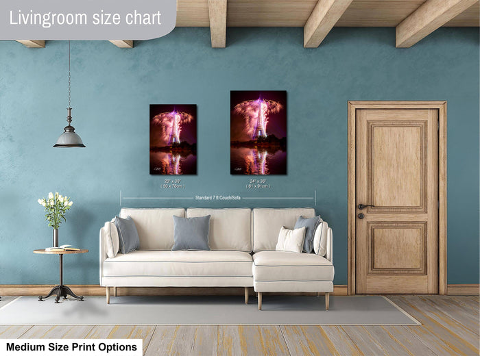 a living room with a white sofa, a wooden door, and a framed artwork depicting a fireworks display on the wall.