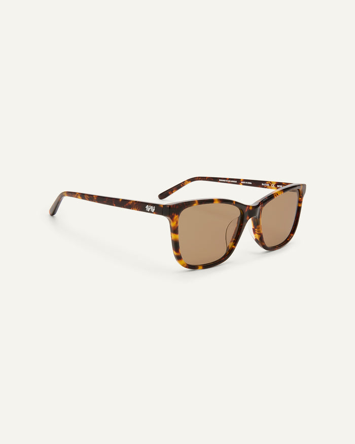 Quarter shot of Bonnie Clyde Bicep sunglasses in tortoise with brown lenses.