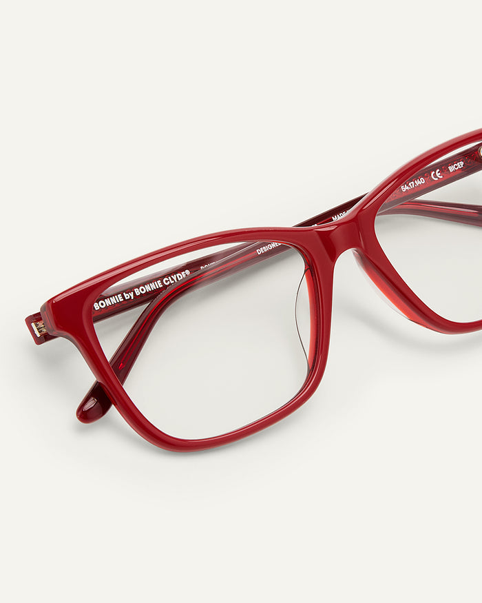 Side shot of Bonnie Clyde Bicep optical frames in layered red with clear lenses.
