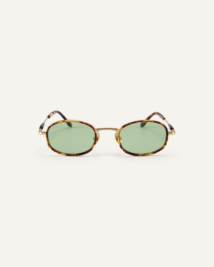 Face shot of Bonnie Clyde Bicycle sunglasses in gold and tortoise with green lenses.
