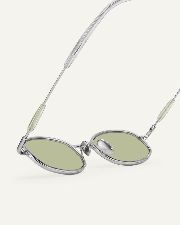 Side shot of Bonnie Clyde Bicycle sunglasses in silver with green lenses.