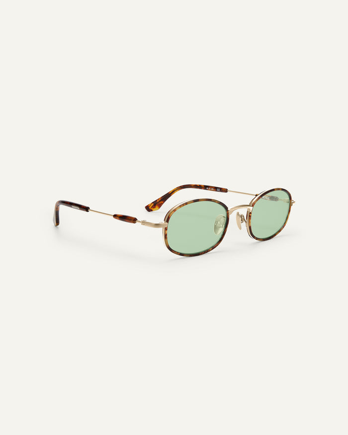 Side shot of Bonnie Clyde Bicycle sunglasses in gold and tortoise with green lenses.