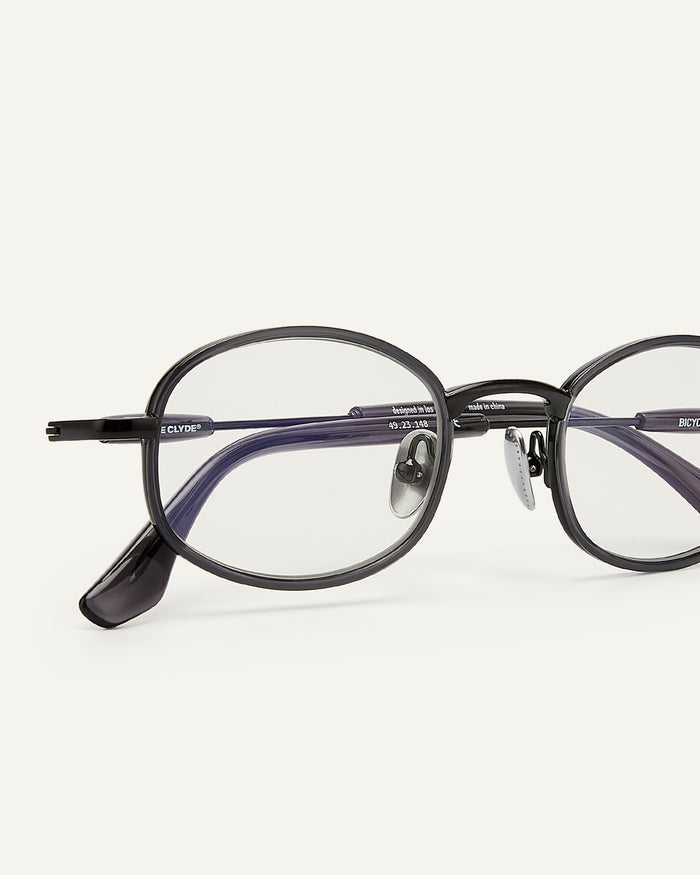 Side shot of Bonnie Clyde Bicycle optical frames in grey with clear lenses.