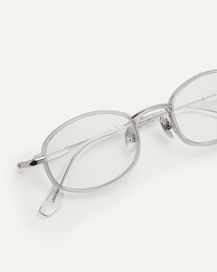 Side shot of Bonnie Clyde Bicycle optical frames in silver with clear lenses.