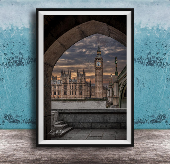 a framed view of the Palace of Westminster and Big Ben in London, England, with the iconic clock tower visible against a dramatic sky.