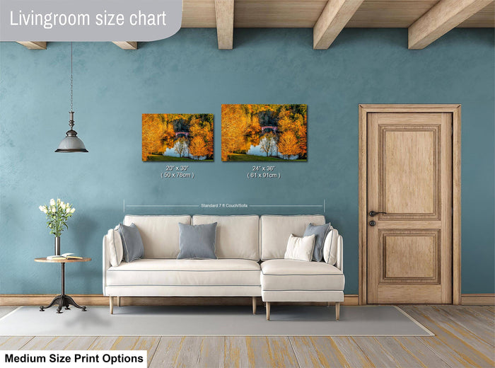 a living room with a white sofa, a wooden door, and a painting of a scenic landscape on the wall.