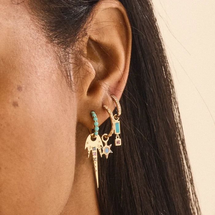 Blessings Abound Turquoise Earring Charm in 10k yellow gold with turquoise and pink tourmaline gemstones, shown worn on hand