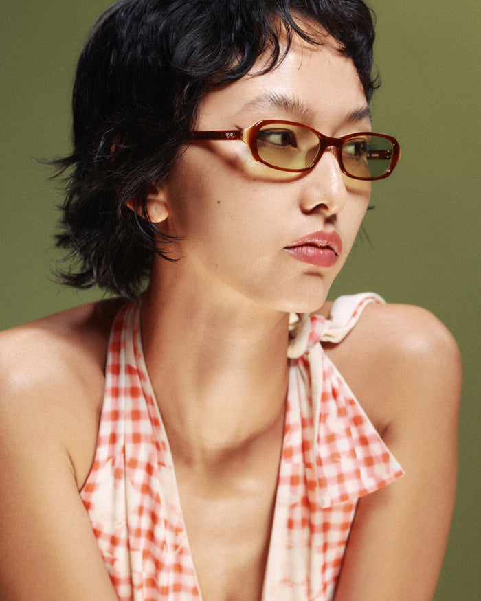 Quarter shot of Bonnie Clyde Blondie sunglasses in brown with green lenses.