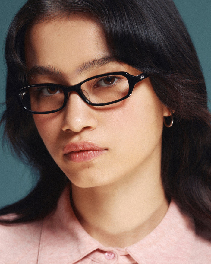 Quarter shot of Bonnie Clyde Blondie optical frames in black with clear lenses.
