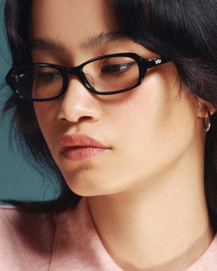 Side shot of Bonnie Clyde Blondie optical frames in black with clear lenses.