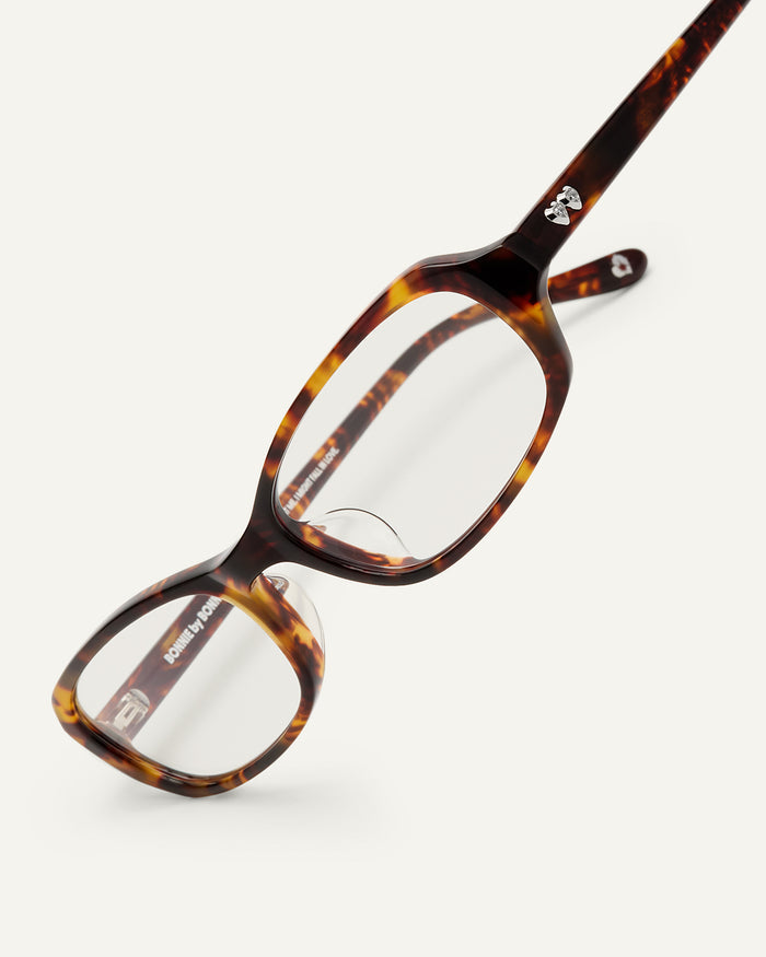 Close-up shot of Bonnie Clyde Blondie optical frames in tortoise with clear lenses.