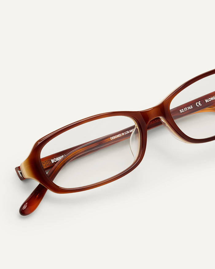 Close-up shot of Bonnie Clyde Blondie optical frames in layered brown with clear lenses.