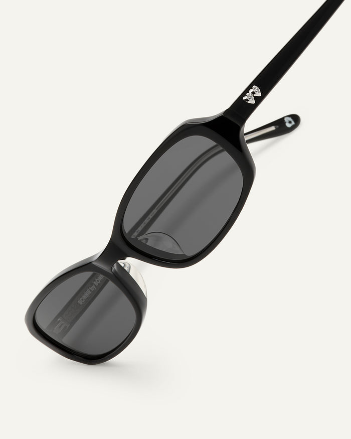 Detail shot of Bonnie Clyde Blondie sunglasses in black with black lenses.