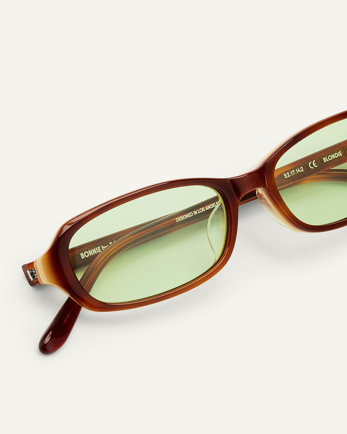 Detail shot of Bonnie Clyde Blondie sunglasses in brown with green lenses.